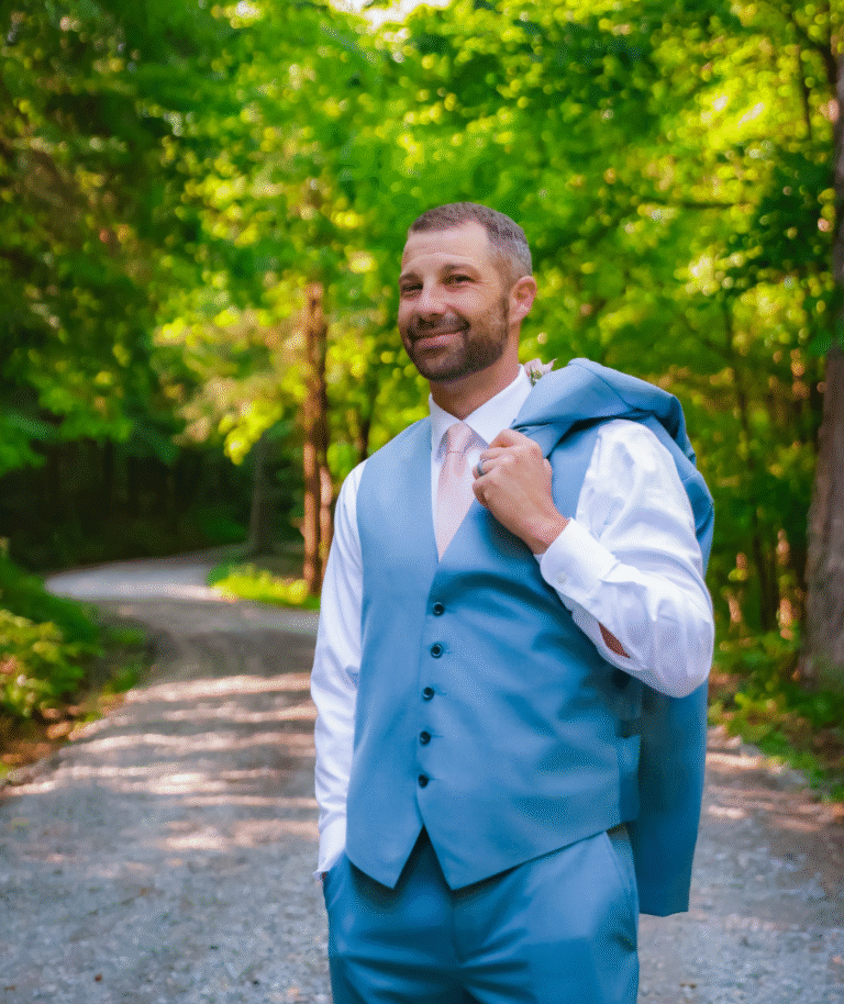One of the owners in a blue suit with a suit jacket over his shoulder